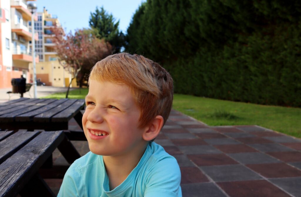 Young boy squinting to see into the distance