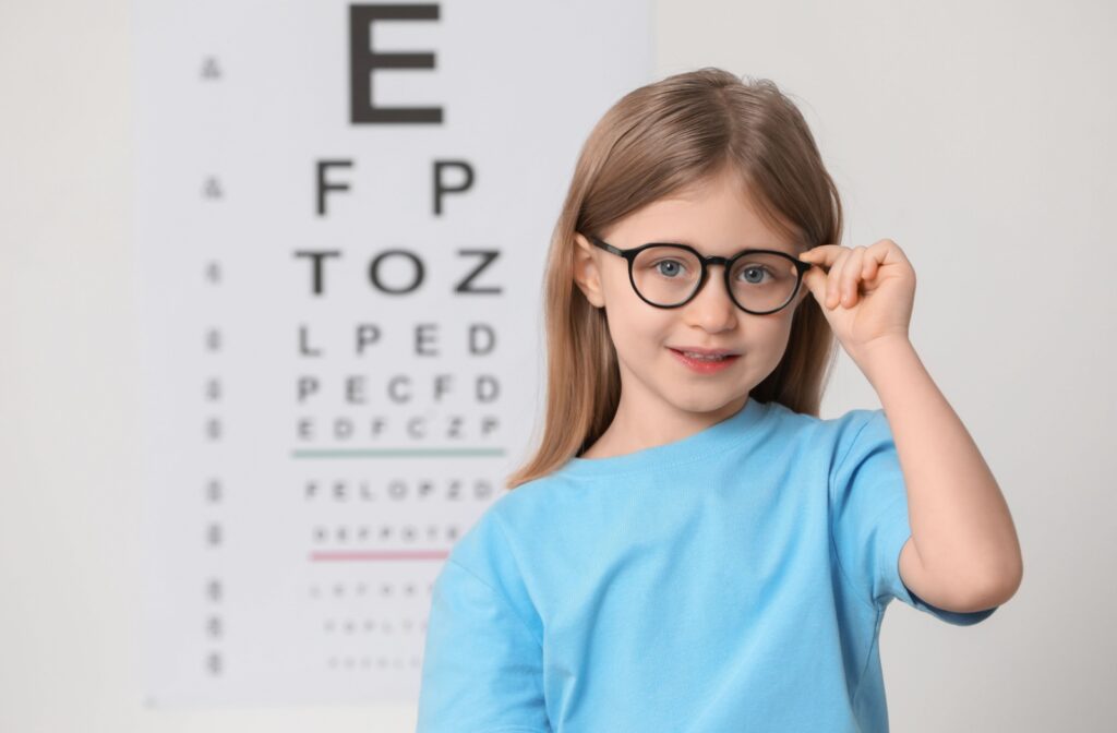 Young girl wearing glasses during vision test.