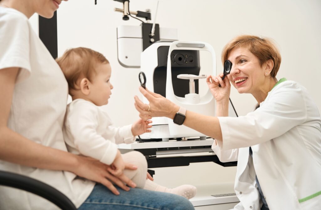 A 6 to 9 month old attending their first eye exam with their parent.