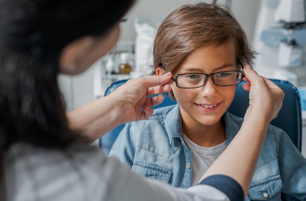 A child is getting fitted for a pair of brown myopia glasses