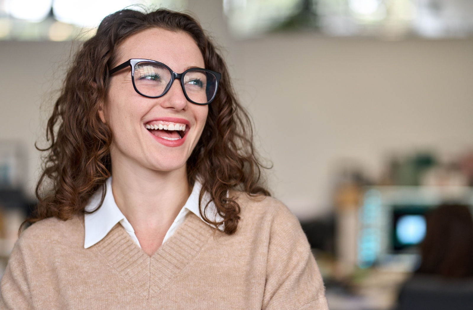 A person wearing black frames glasses and smiling